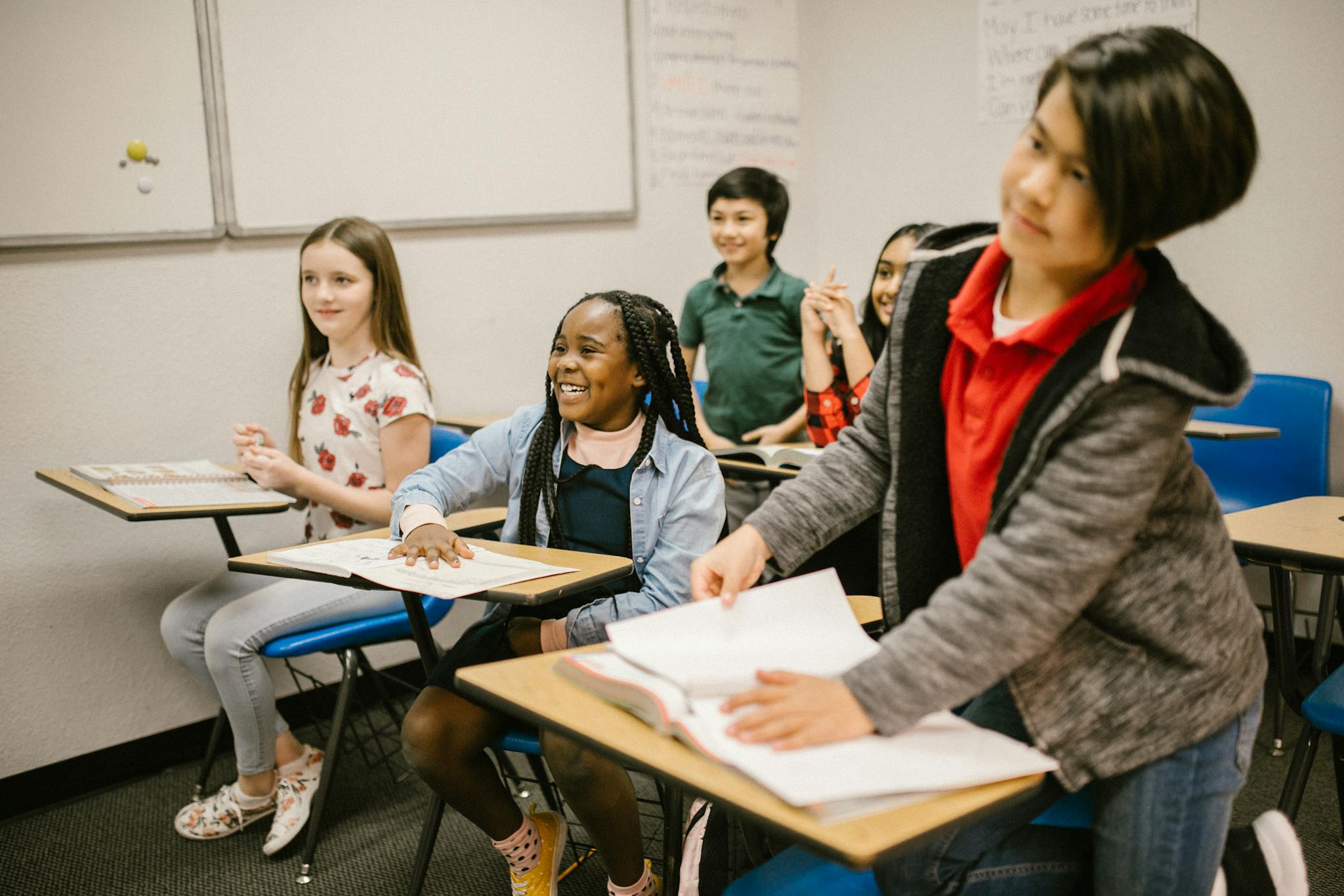 A group of diverse students actively participating in a classroom setting, promoting inclusivity and learning.